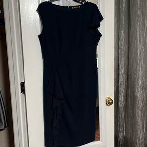 Dress with One ruffled sleeve and ruffle down the front. Plain back navy blue